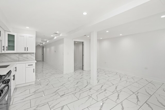 6610 S Saint Lawrence Ave, Chicago, IL 60637 - kitchen with black gas range, recessed lighting, glass insert cabinets, light countertops, and baseboards
