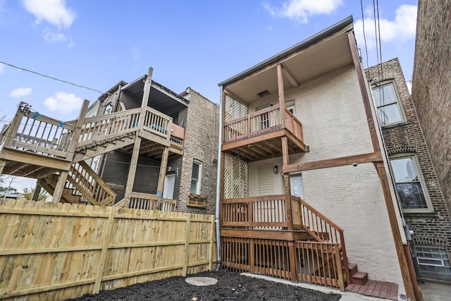 6610 S Saint Lawrence Ave, Chicago, IL 60637 - back of property with brick siding, fence, stairs, a balcony, and a wooden deck