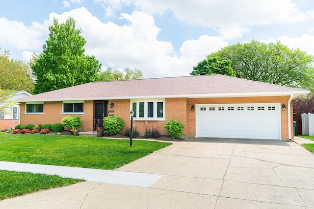854 Meadow Ln, Sycamore, IL 60178 - ranch-style house featuring a garage, driveway, brick siding, a front yard, and roof with shingles