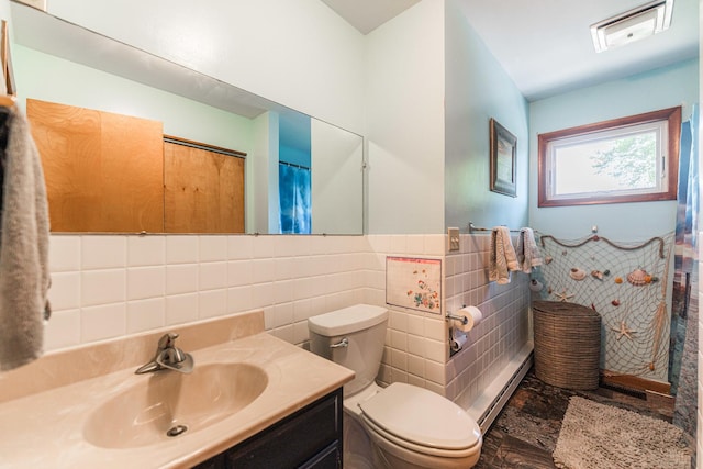 854 Meadow Ln, Sycamore, IL 60178 - full bath with tile walls, baseboard heating, toilet, vanity, and wainscoting