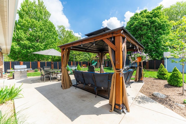 854 Meadow Ln, Sycamore, IL 60178 - view of patio with a gazebo, a fenced backyard, a shed, outdoor dining space, and an outdoor hangout area