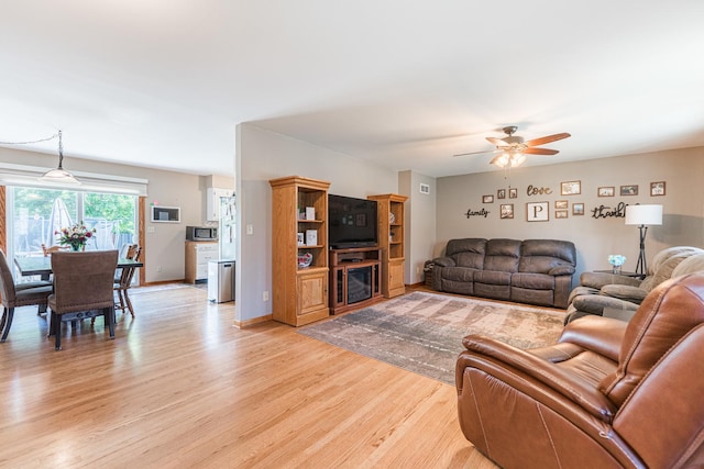 854 Meadow Ln, Sycamore, IL 60178 - living area featuring light wood finished floors, a ceiling fan, and baseboards