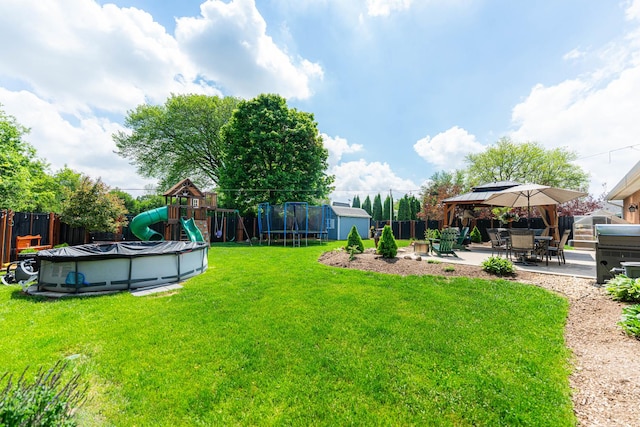 854 Meadow Ln, Sycamore, IL 60178 - view of yard with a storage unit, a playground, a trampoline, a patio area, and an outdoor structure