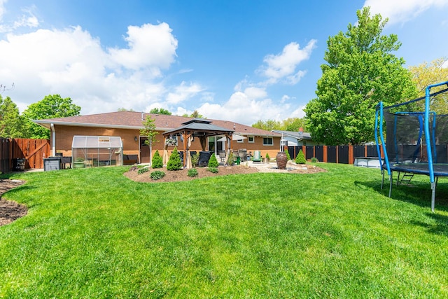 854 Meadow Ln, Sycamore, IL 60178 - back of house with a trampoline, a gazebo, and a patio area