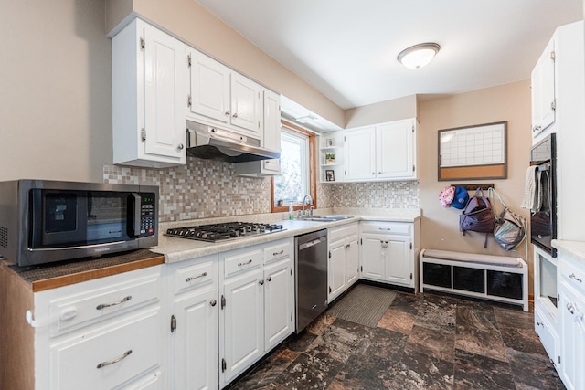 854 Meadow Ln, Sycamore, IL 60178 - kitchen with appliances with stainless steel finishes, under cabinet range hood, a sink, and white cabinetry