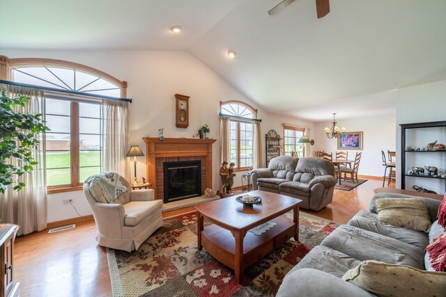 471 Linden Cir, Beecher, IL 60401 - living room with light wood-style flooring, a chandelier, plenty of natural light, lofted ceiling, and a fireplace