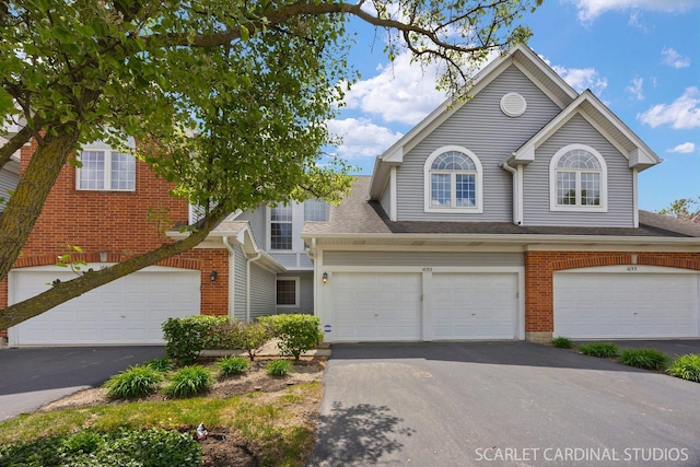1653 W Ethans Glen Dr, Palatine, IL 60067 - view of front of property featuring driveway, brick siding, an attached garage, and a shingled roof