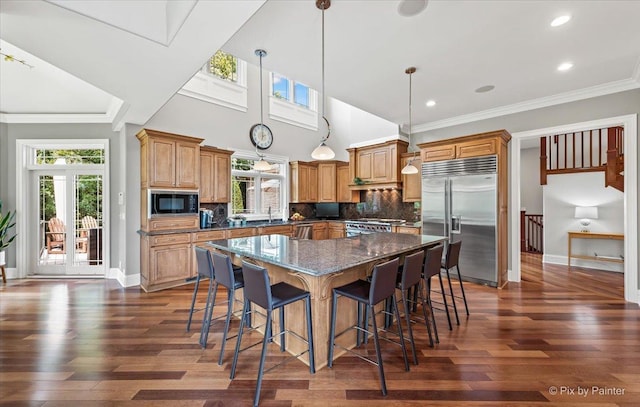 7N627 E Drive S, Elgin, IL 60177 - kitchen featuring built in appliances, plenty of natural light, a kitchen island, a kitchen bar, and recessed lighting