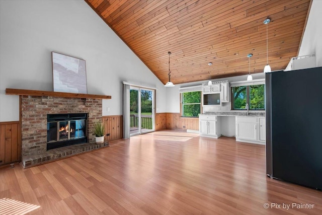 7N627 E Drive S, Elgin, IL 60177 - unfurnished living room with wood ceiling, a wainscoted wall, light wood-type flooring, high vaulted ceiling, and wood walls