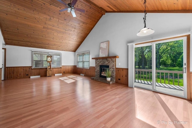 7N627 E Drive S, Elgin, IL 60177 - unfurnished living room featuring a wainscoted wall, wood ceiling, light wood-style floors, wood walls, and high vaulted ceiling