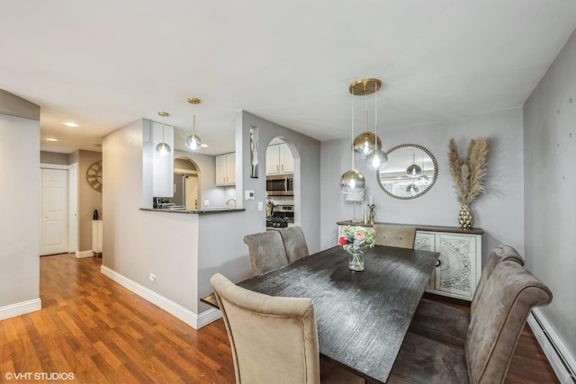 1116 S New Wilke Rd Unit 107, Arlington Heights, IL 60005 - dining space featuring a baseboard heating unit, wood finished floors, arched walkways, baseboards, and recessed lighting