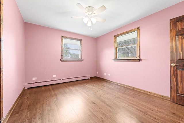 208 Ridge St, Algonquin, IL 60102 - spare room featuring baseboard heating, plenty of natural light, wood finished floors, and a ceiling fan