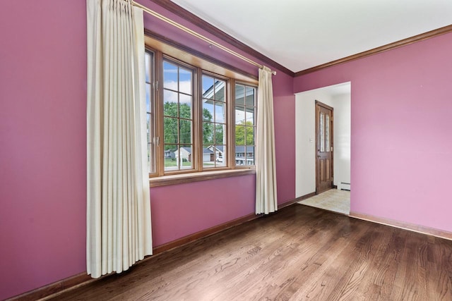 208 Ridge St, Algonquin, IL 60102 - spare room featuring wood finished floors, ornamental molding, baseboards, and baseboard heating