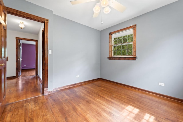 208 Ridge St, Algonquin, IL 60102 - unfurnished room featuring wood finished floors, baseboards, a ceiling fan, and a baseboard heating unit