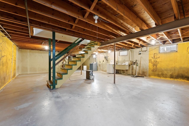 208 Ridge St, Algonquin, IL 60102 - below grade area with washing machine and clothes dryer, stairs, and a sink