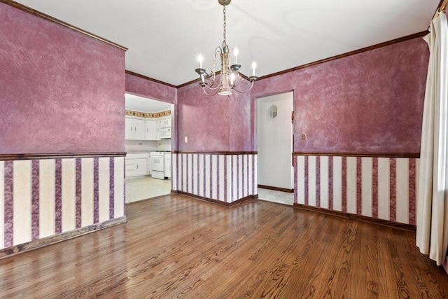 208 Ridge St, Algonquin, IL 60102 - spare room with wood finished floors, a chandelier, and ornamental molding