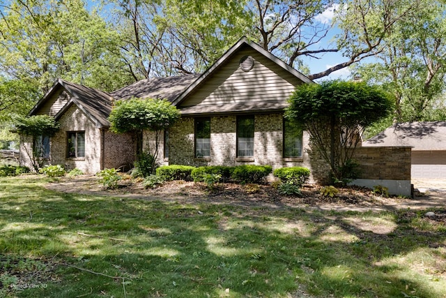 340 S Francis St, Braidwood, IL 60408 - view of front of property featuring a front lawn, brick siding, and a garage