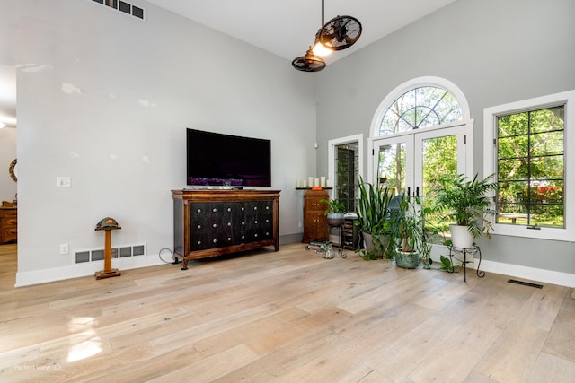 340 S Francis St, Braidwood, IL 60408 - living area featuring high vaulted ceiling, hardwood / wood-style flooring, french doors, and baseboards