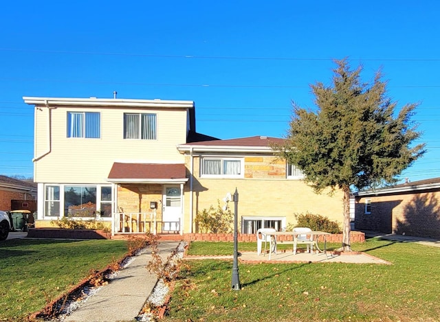 5644 Lyons St, Morton Grove, IL 60053 - rear view of property with a lawn and a patio area
