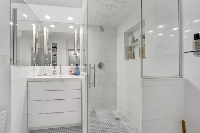 1440 N Lake Shore Dr Unit 4Bd, Chicago, IL 60610 - bathroom with a stall shower, vanity, tile walls, recessed lighting, and tile patterned flooring