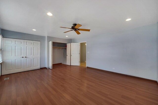 706 Shining Water Dr, Carol Stream, IL 60188 - unfurnished bedroom with baseboards, two closets, wood finished floors, recessed lighting, and a ceiling fan