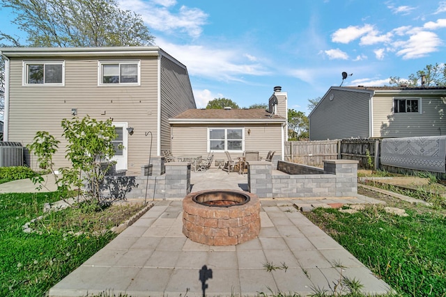 706 Shining Water Dr, Carol Stream, IL 60188 - back of property with a patio, an outdoor fire pit, fence, a chimney, and cooling unit