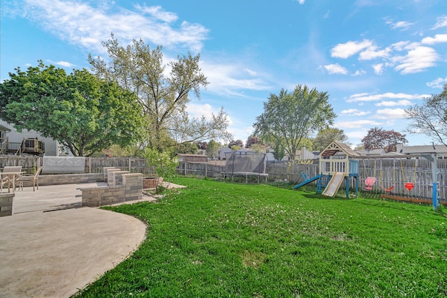 706 Shining Water Dr, Carol Stream, IL 60188 - view of yard featuring a trampoline, a playground, and a patio area
