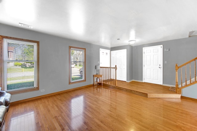 706 Shining Water Dr, Carol Stream, IL 60188 - unfurnished living room with wood finished floors, baseboards, and stairs