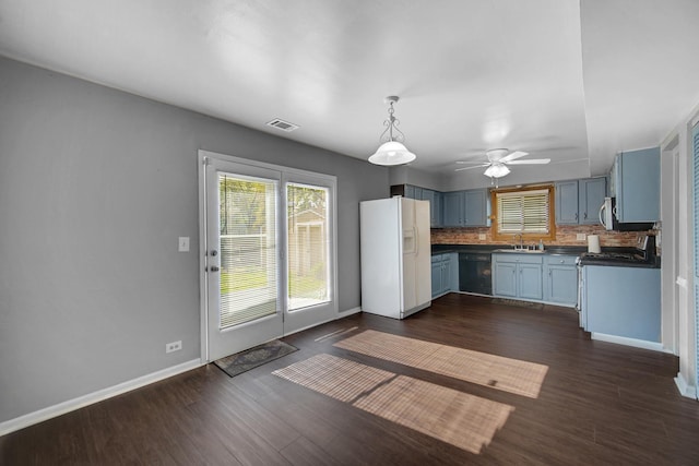 706 Shining Water Dr, Carol Stream, IL 60188 - kitchen with white refrigerator with ice dispenser, a sink, dark countertops, blue cabinetry, and a ceiling fan
