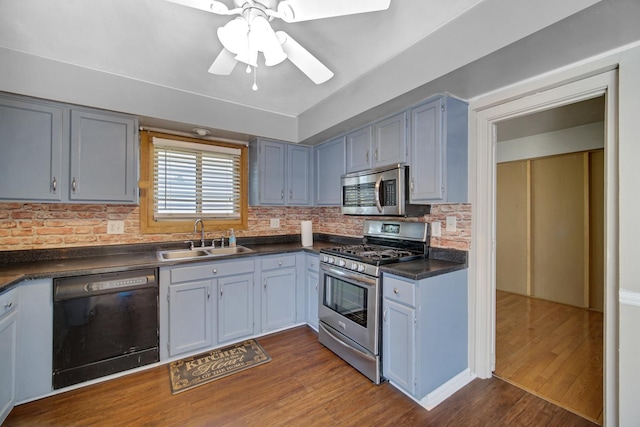 706 Shining Water Dr, Carol Stream, IL 60188 - kitchen with stainless steel appliances, a sink, dark countertops, decorative backsplash, and dark wood-style flooring