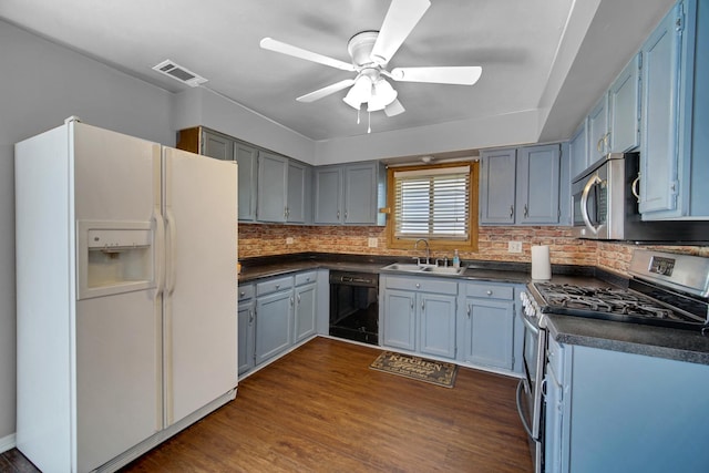 706 Shining Water Dr, Carol Stream, IL 60188 - kitchen featuring stainless steel appliances, a sink, dark countertops, ceiling fan, and tasteful backsplash