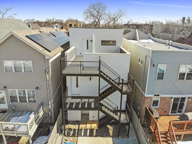 rear view of property with stairs, a residential view, and a wooden deck