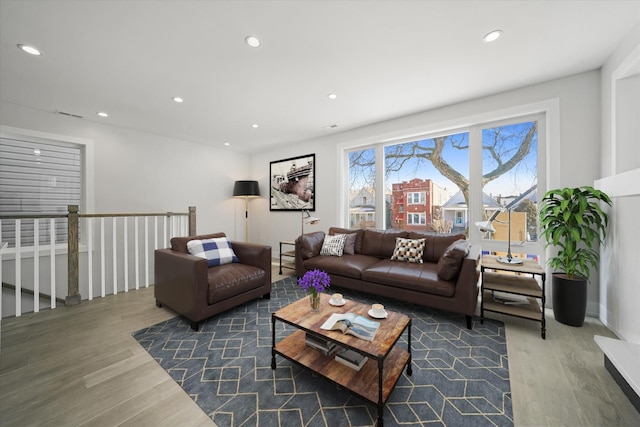 living area featuring wood finished floors and recessed lighting