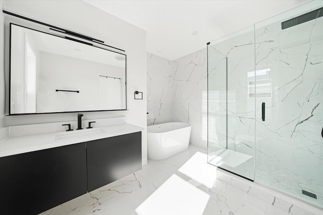 full bathroom featuring vanity, a soaking tub, a marble finish shower, and marble tiled floors