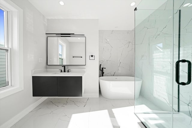 bathroom with marble tiled floors, a freestanding tub, a marble finish shower, vanity, and recessed lighting