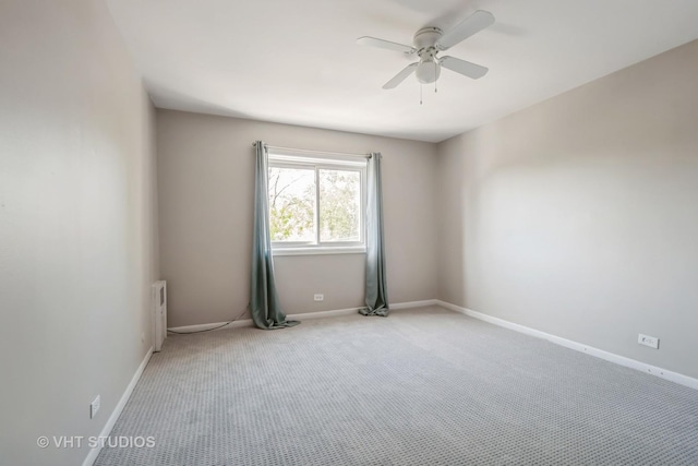 5251 W Galitz St Unit 309, Skokie, IL 60077 - spare room featuring ceiling fan, light carpet, baseboards, and radiator heating unit
