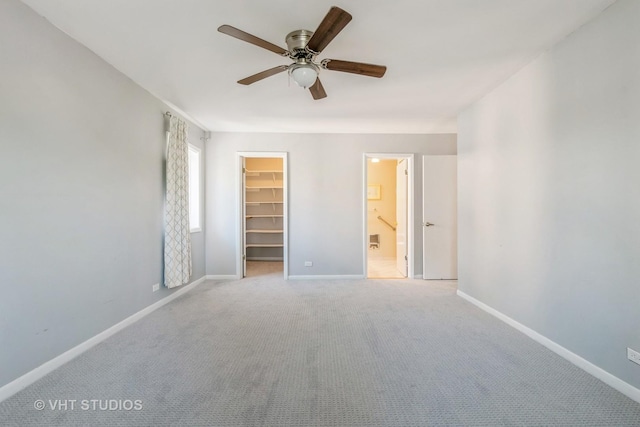 5251 W Galitz St Unit 309, Skokie, IL 60077 - unfurnished bedroom with a walk in closet, a closet, baseboards, and light carpet