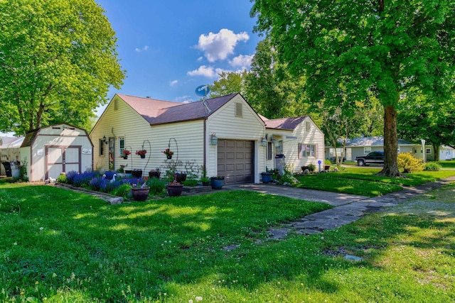 606 E Houghton St, Tuscola, IL 61953 - view of front of home with a garage, a shed, a front yard, driveway, and an outdoor structure