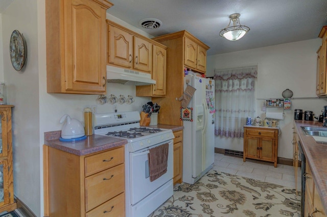 606 E Houghton St, Tuscola, IL 61953 - kitchen with white appliances, under cabinet range hood, a sink, light tile patterned floors, and baseboards
