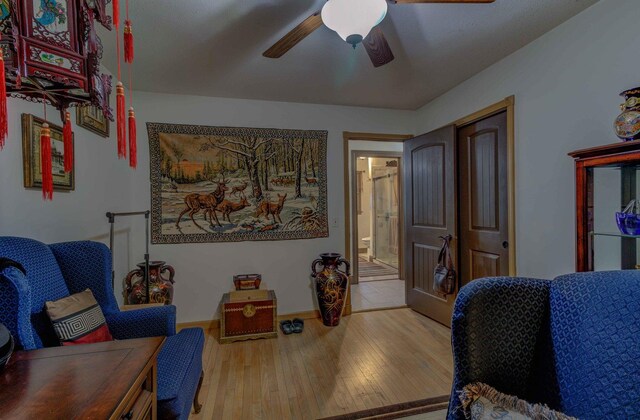 606 E Houghton St, Tuscola, IL 61953 - living area featuring a ceiling fan, wood finished floors, and baseboards