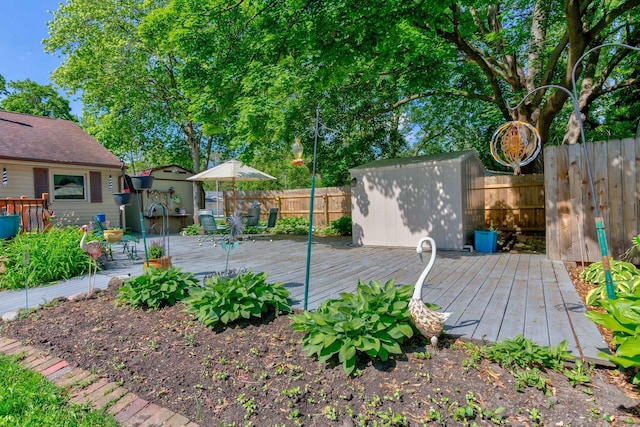 606 E Houghton St, Tuscola, IL 61953 - deck featuring a shed, an outdoor structure, and a fenced backyard
