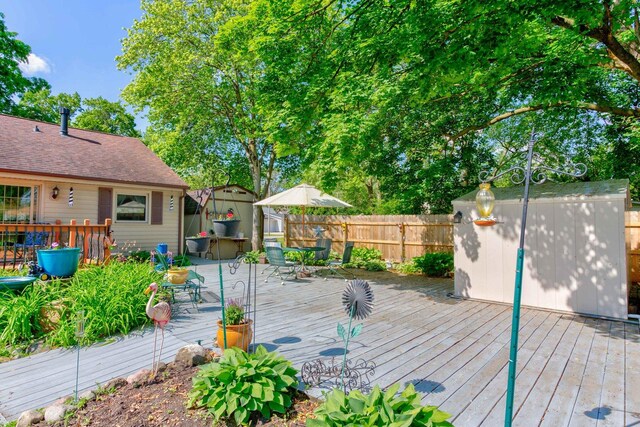 606 E Houghton St, Tuscola, IL 61953 - wooden deck with a storage shed, an outdoor structure, and a fenced backyard