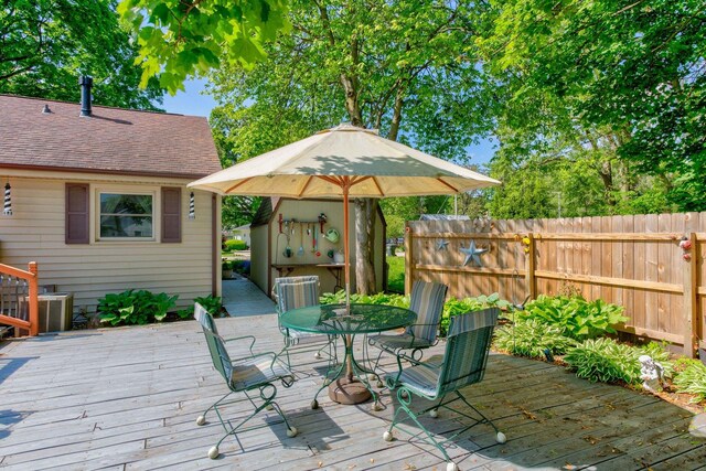 606 E Houghton St, Tuscola, IL 61953 - wooden terrace with outdoor dining space and fence
