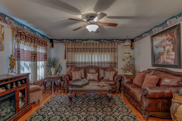 606 E Houghton St, Tuscola, IL 61953 - living area featuring a ceiling fan, wood finished floors, and a textured ceiling