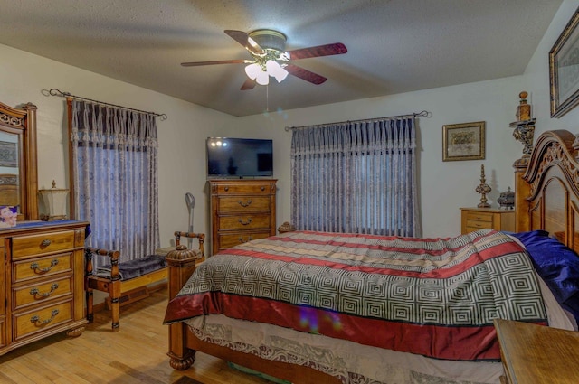 606 E Houghton St, Tuscola, IL 61953 - bedroom featuring wood finished floors, ceiling fan, and a textured ceiling