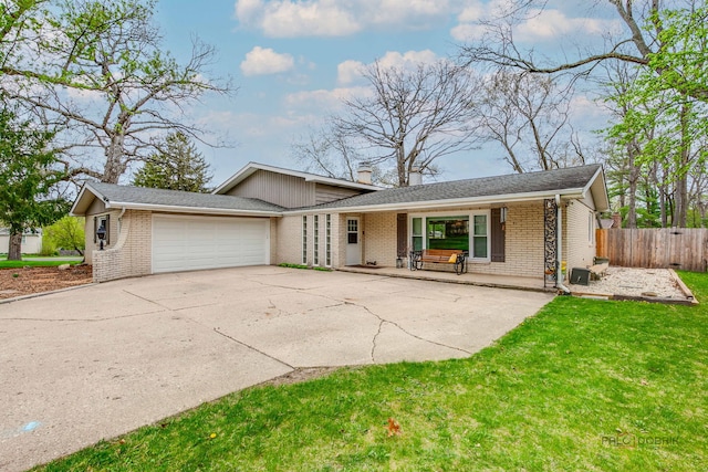 5045 S Rd, Gurnee, IL 60031 - view of front facade featuring brick siding, an attached garage, concrete driveway, and a porch