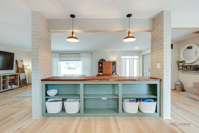 5045 S Rd, Gurnee, IL 60031 - kitchen featuring decorative columns, wood counters, and wood finished floors