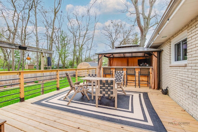 5045 S Rd, Gurnee, IL 60031 - wooden terrace featuring a fenced backyard, outdoor dining space, and a gazebo