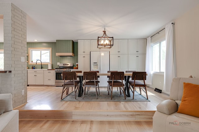 5045 S Rd, Gurnee, IL 60031 - dining space featuring a chandelier, light wood finished floors, and ornate columns