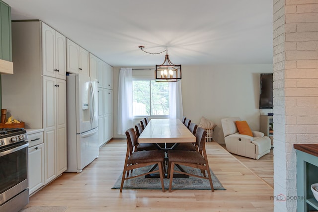 5045 S Rd, Gurnee, IL 60031 - dining area featuring light wood finished floors and a chandelier